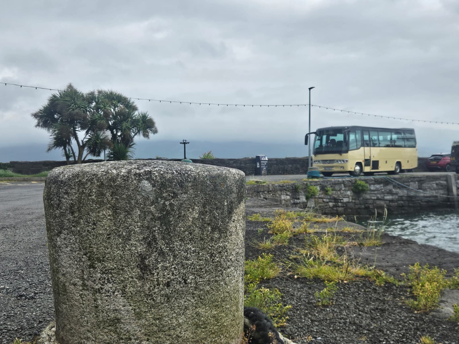A Paynes coach parked by an Irish harbour