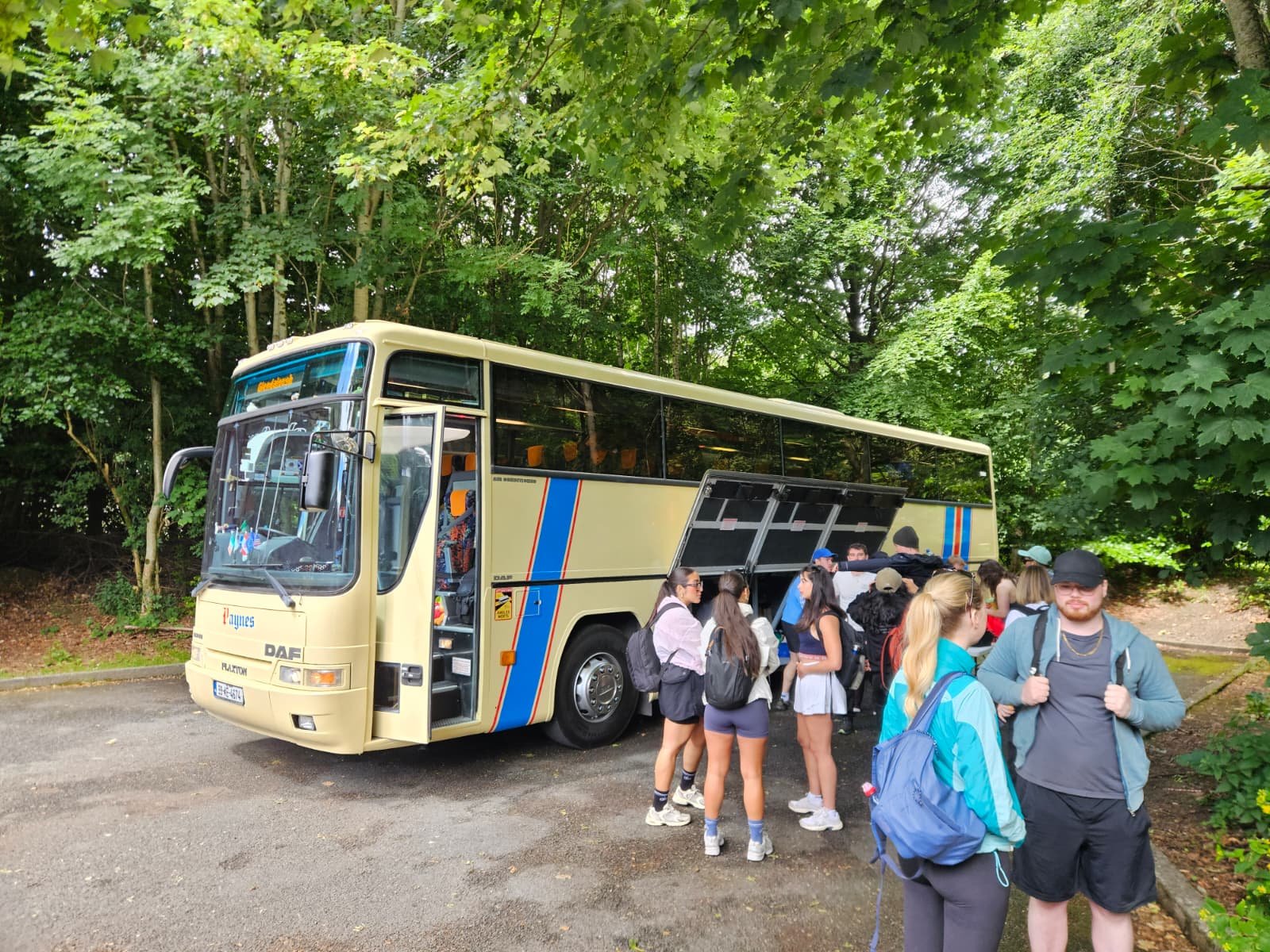 Passengers boarding a Paynes coach at night