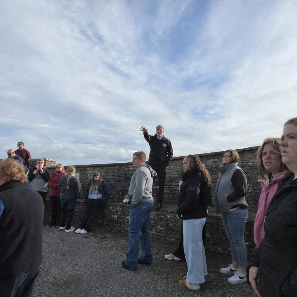 Tour guide addressing a group at an Irish castle